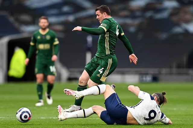 LONDON, ENGLAND - MAY 02: Gareth Bale of Tottenham Hotspur tackles John Fleck of Sheffield United during the Premier League match between Tottenham Hotspur and Sheffield United at Tottenham Hotspur Stadium on May 02, 2021 in London, England. Sporting stadiums around the UK remain under strict restrictions due to the Coronavirus Pandemic as Government social distancing laws prohibit fans inside venues resulting in games being played behind closed doors. (Photo by Shaun Botterill/Getty Images)