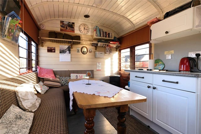 This fully serviced former railway carriage known as the ‘camping coach’ is currently used as a successful holiday let with two bedrooms, a dining kitchen, shower room and private garden space.