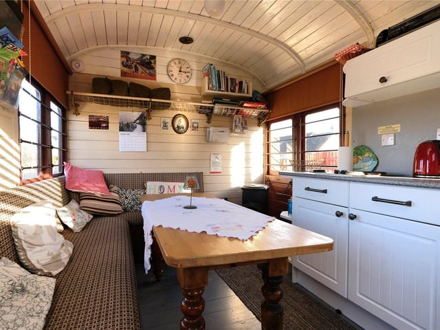 This fully serviced former railway carriage known as the ‘camping coach’ is currently used as a successful holiday let with two bedrooms, a dining kitchen, shower room and private garden space.