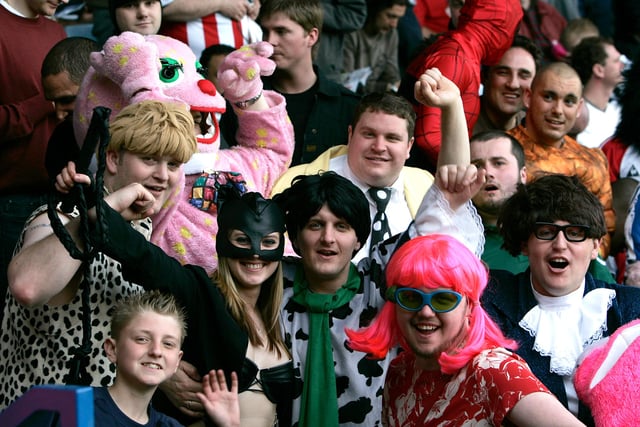 United fans decked out in fancy dress are in high spirits as they watch their already promoted side take on Luton Town in the Championship in April 2006.