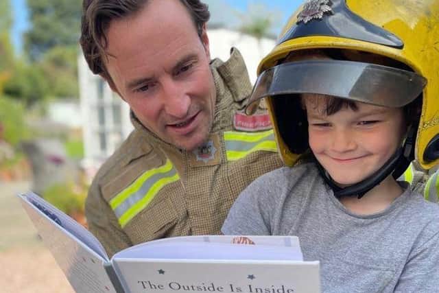 Firefighter Joe Moorwood reads to son Max, five