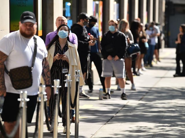 Queueing customers were seen wearing face masks while waiting to enter a Selfridges department store on Oxford Street in London.