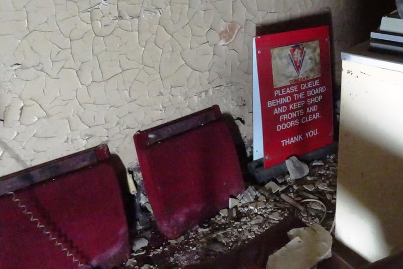 The distinctive red chairs have been removed from the cinemas... but a few of them can still be found in the building, along with old signage (Pic: John Murray)