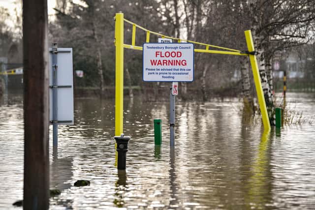 A flood warning sign at the entrance to a flooded car park beside Tewkesbury Abbey, where flood watches are in place with more wet weather expected in the coming days.