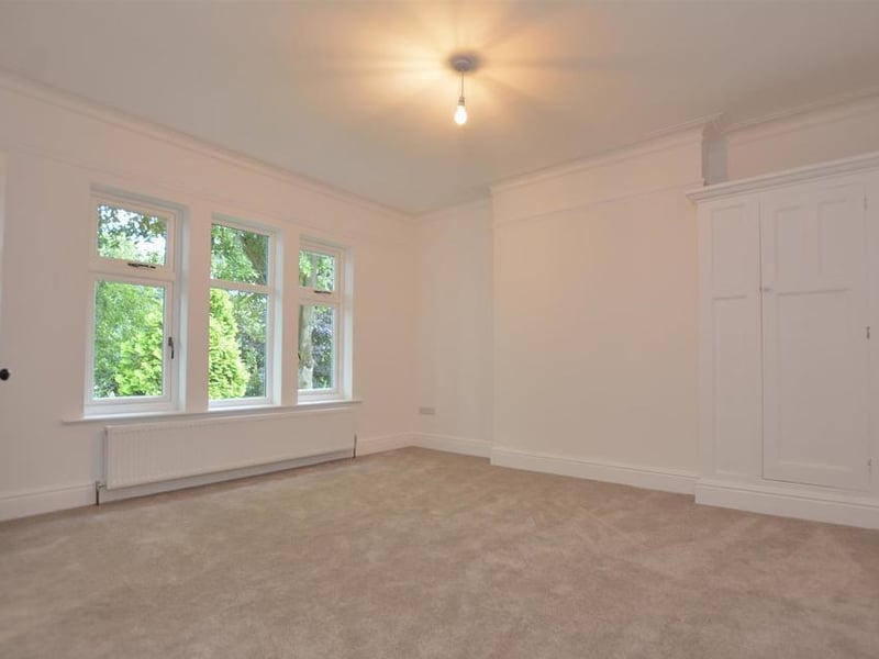 Another stylish and substantial bedroom. It includes a wardrobe with hanging rails and shelves and three double-glazed windows to the front, plus access to an en-suite shower room.