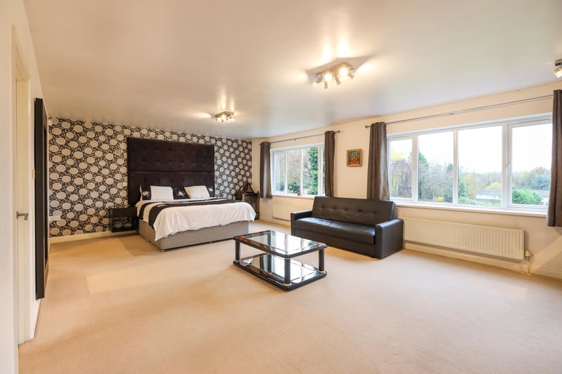 This spacious bedroom is one of six at the property