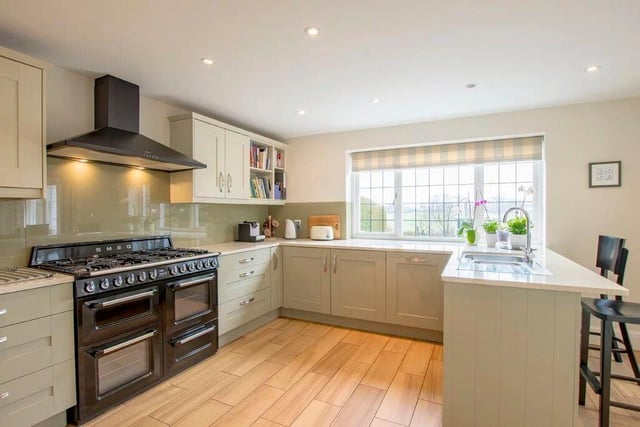 The large living kitchen has granite worktops and a lovely view over the garden and playing fields.