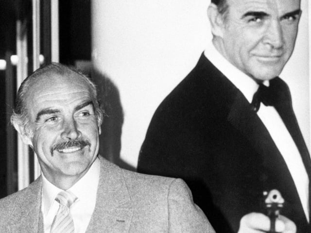Backed by his own likeness as James Bond in 1962, actor Sean Connery, 53 son of a Scottish mill-worker, whose latest film, Never Say Never Again opens at the Warner Theatre, Leicester Square.