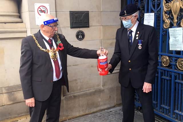 The Lord Mayor of Sheffield Tony Downing accepted the first poppy of the year from Bryan Green