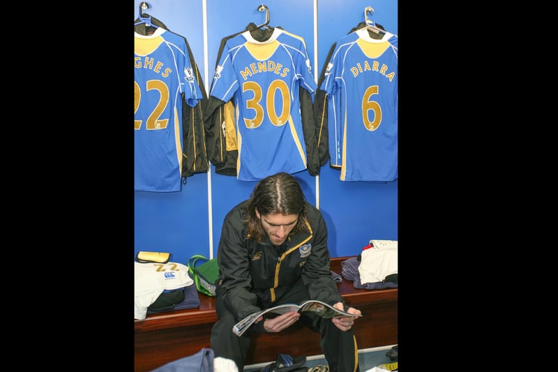 Pedro Mendes takes a look through the Pompey programme before taking the field.  Picture: Habibur Rahman
