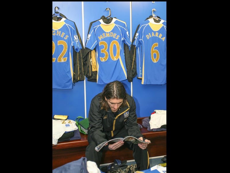 Pedro Mendes takes a look through the Pompey programme before taking the field.  Picture: Habibur Rahman