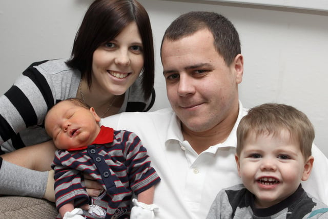 Harry James Bradbury weighed in at 9lb 80z on the first day of 2011. He is pictured with mum Sarah Riley, dad Craig Bradbury and brother Connor (Jack) Riley at home in Newbold, Chesterfield.