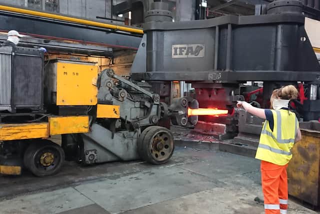 Forge workers wear anti-virus snoods at Independent Forgings and Alloys.