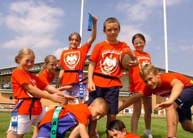 A bunch of kids playing tag rugby at the multi sport summer fun camp hosted by Doncaster Rugby Club in 2006.