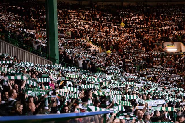 Celtic fans hold aloft scarves ahead of the UEFA Champions League Group C football match between Celtic and Manchester City at Celtic Park stadium in Glasgow, Scotland on September 28, 2016. (Photo by OLI SCARFF / AFP)        (Photo credit should read OLI SCARFF/AFP via Getty Images)