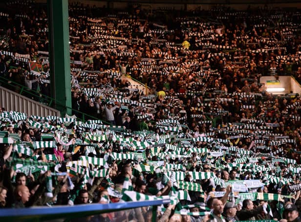 Celtic fans hold aloft scarves ahead of the UEFA Champions League Group C football match between Celtic and Manchester City at Celtic Park stadium in Glasgow, Scotland on September 28, 2016. (Photo by OLI SCARFF / AFP)        (Photo credit should read OLI SCARFF/AFP via Getty Images)