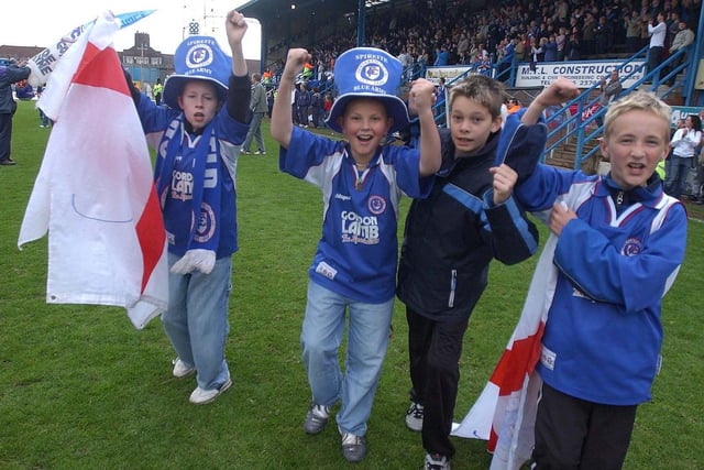 Chesterfield fans celebrate after Town escape relegation.
