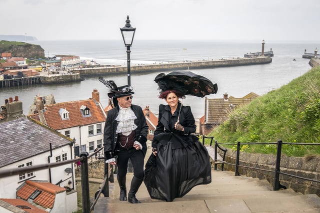 A couple showing off their outfits on Whitby's 199 steps