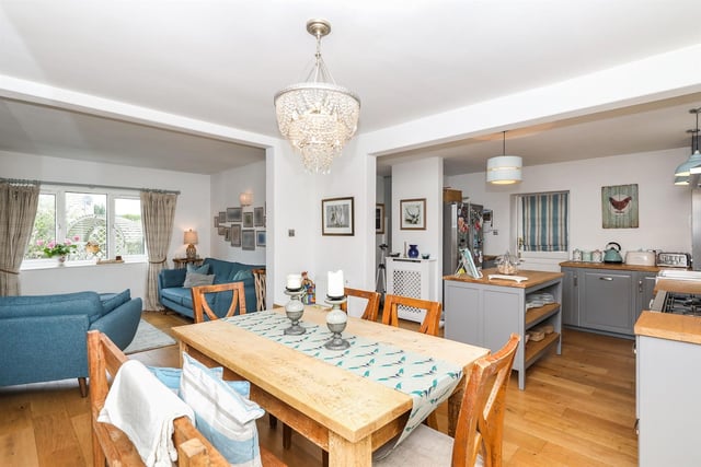 The dining room is linked to the kitchen and sitting room, and features an open fire with a stone hearth. Double glazed french doors open onto the rear of the cottage.