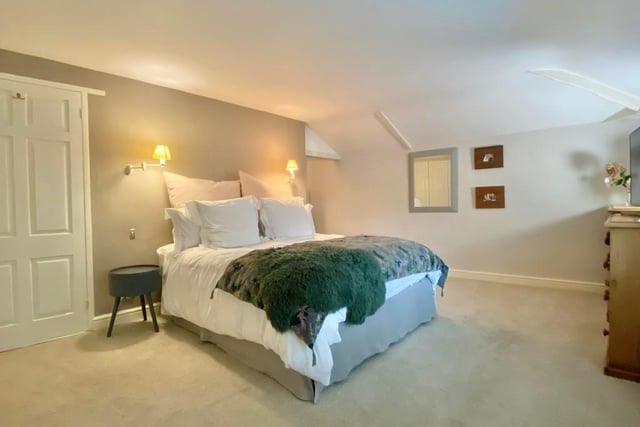 A delightful master bedroom, which is at the back of the property and has double-glazed windows overlooking the garden. It features a walk-in wardrobe and a range of built-in hanging and storage facilities.
