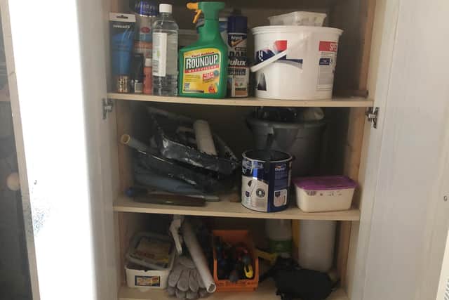 DIY cupboard with paint and other tools.