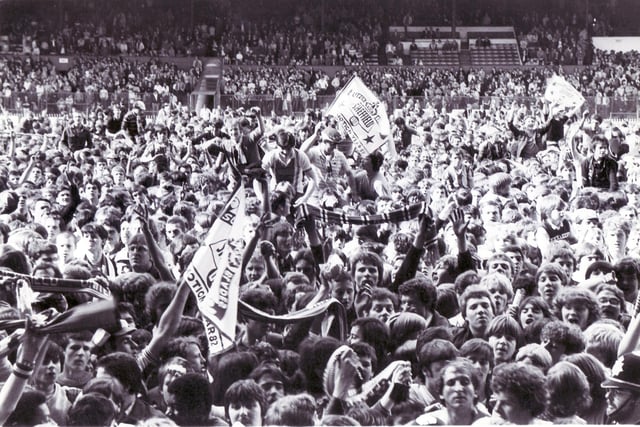 Jubilant fans celebrate United's promotion to Division Three after a 4-0 win over Peterborough United in their final home game of the 1981/82 season.