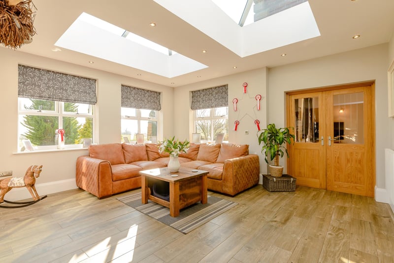 The sun room boasts two large roof lanterns that saturate the room with natural light and bi-folding doors open the room out to the gardens.