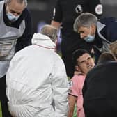 Sheffield United's John Egan is attended to by medics before being stretchered off at West Ham (Glyn Kirk/Pool via AP)