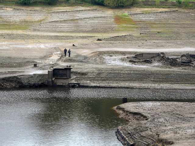 People inspect the ruins of Derwent Village. (Photo by Christopher Furlong/Getty Images)