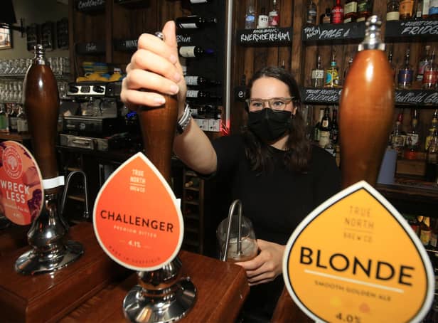 Pulling a pint at the Riverside Kelham on Monday is Lauren Griggs. Picture: Chris Etchells