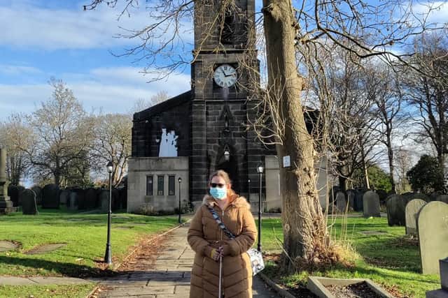 Photo of Amy standing in front of the church