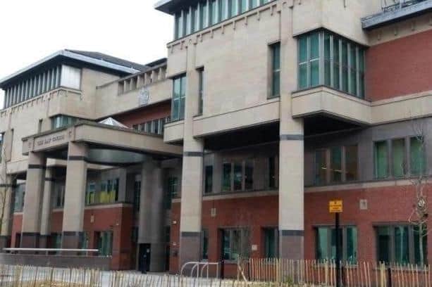 Sheffield Crown Court, pictured, has heard how a Sheffield thug has narrowly been spared from prison after he struck a woman three times.