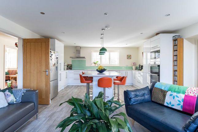 This large family kitchen boasts plenty of space for a large dining table and a sofa, making it the perfect space for entertaining