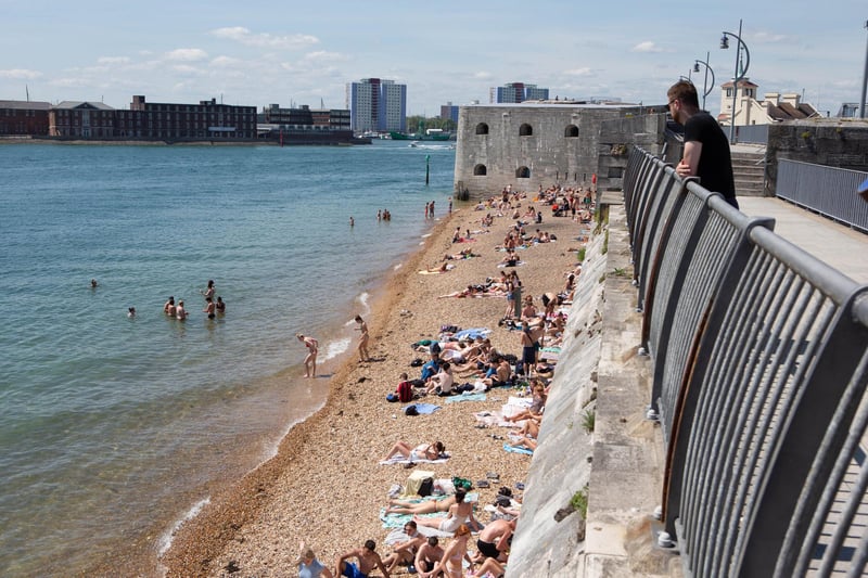 People making the most of the warm weather at the Hot Walls in Old Portsmouth. Picture: Habibur Rahman