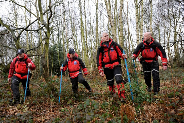 Pictured are members of Woodhead Mountain rescue who are helping police search woods off Lawton Lane, Moorgate,Rotherham, for a missing person