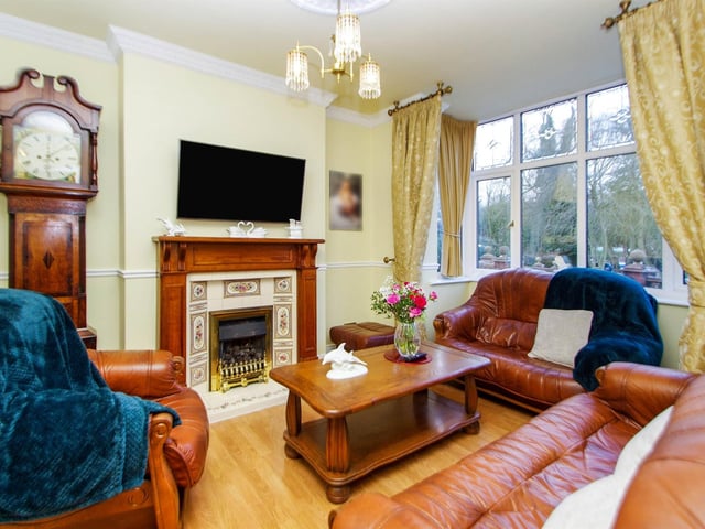 UPVC bay window to front, feature fire surround with inset living flame gas fire and decorative tiles, laminate flooring and radiator.