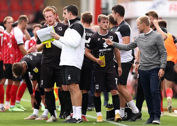 CHELTENHAM, ENGLAND - SEPTEMBER 04: Liam Manning, manager of MK Dons,  speaks to his players during the Sky Bet League One match between Cheltenham Town and Milton Keynes Dons at The Jonny-Rocks Stadium on September 04, 2021 in Cheltenham, England. (Photo by Ryan Pierse/Getty Images)