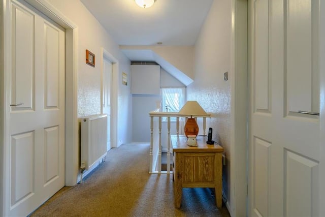 At the top of the stairs, we are greeted by this landing, which links all four bedrooms. It features a hatch leading to a partially boarded loft.