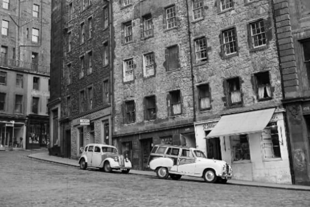 Cars parked at West Bow at the foot of Victoria Street, off the Grassmarket, in September 1961. The tenements had been lying empty for some time and were set to be refurbished by the Edinburgh Corporation.