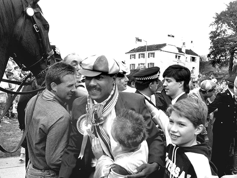 Yellows striker Keith Cassells is mobbed by fans.