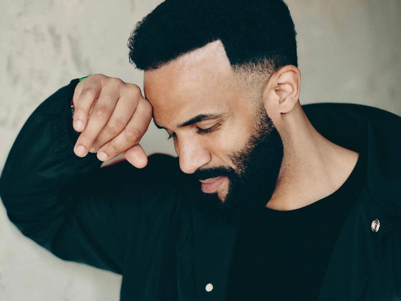 Experience the smooth R&B and garage rhythms of Craig David, live and vibrant under the summer sky.