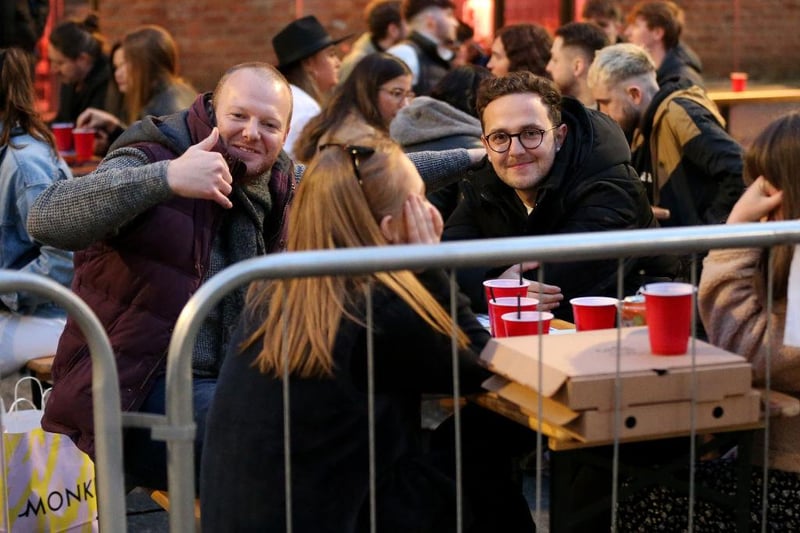 A group of friends react for the camera while drinking in an outdoor seating area on April 16, 2021 in Manchester, England (Photo by Charlotte Tattersall/Getty Images)