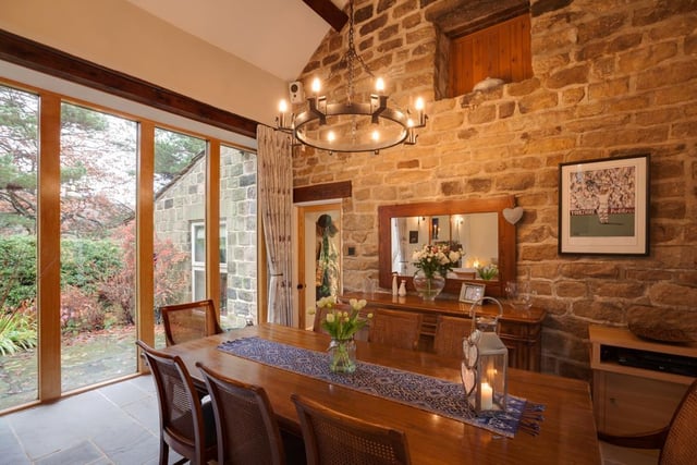 The dining area has rear-facing oak double glazed panels, a vaulted ceiling, exposed beams, a pendant light point and stone flagged flooring with underfloor heating.