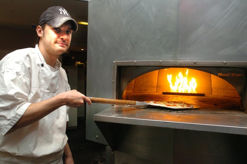 Ben White putting a pizza into the gas fired oven at BRB Pizza in 2005