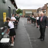 Prime Minister Boris Johnson waits in line in the playground to wash his hands (Photo by Steve Parsons - WPA Pool/Getty Images)
