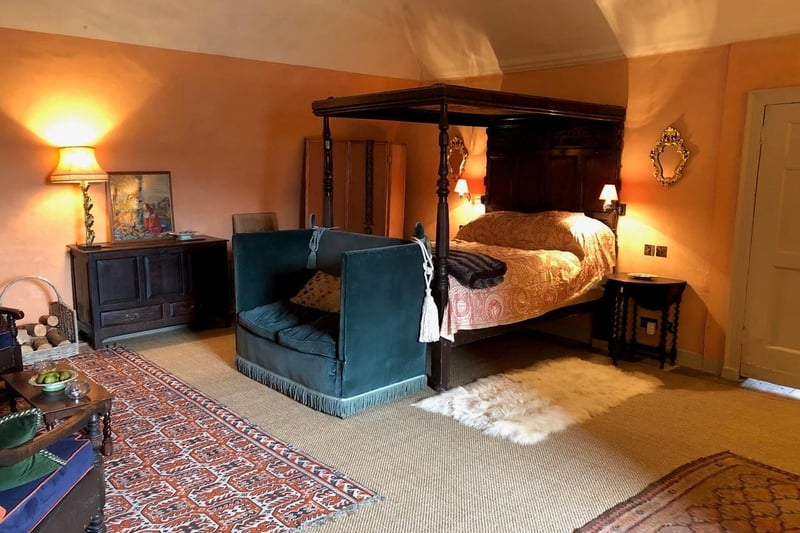 The bedroom's centrepiece is a stunning antique four-poster bed.