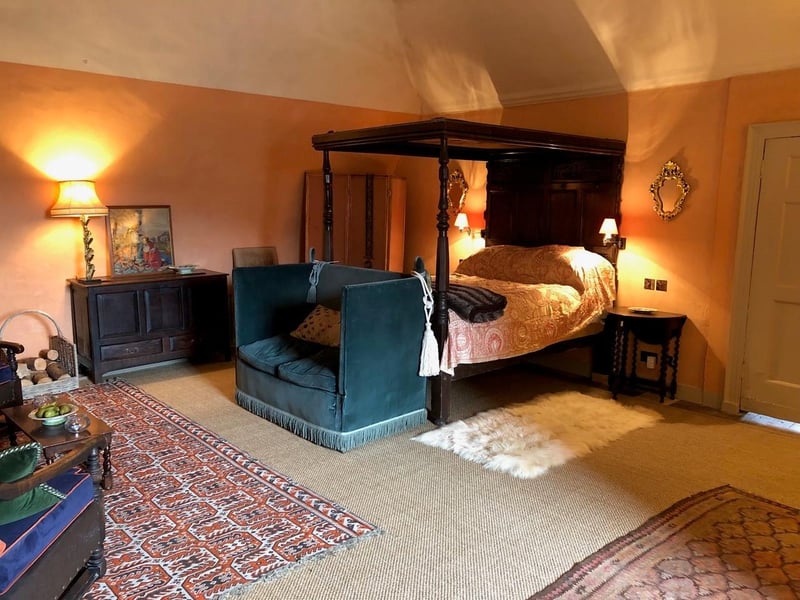 The bedroom's centrepiece is a stunning antique four-poster bed.