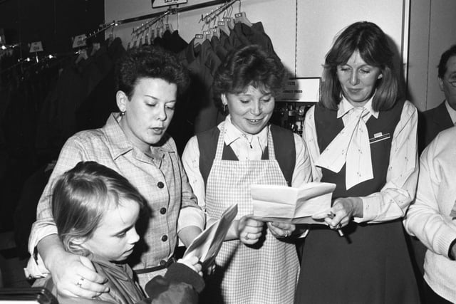 Local singers get in some practice to make sure late Christmas shopping is a cheerful affair at British Home Stores in 1985.