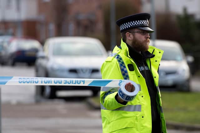 A police officer puts up a cordon (Photo by Matthew Horwood/Getty Images)