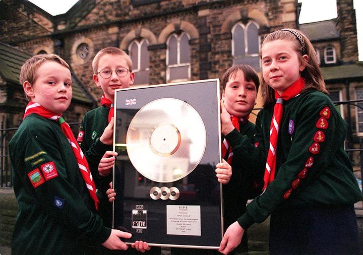 Members of the 270th Intake Scout Group, left to right, Scott Widdowson, Mark Pitts, Antony Marples and Laura France, pictured with the Jarvis Cocker platinum disc outside Intake Methodist Church, on April 1, 1998